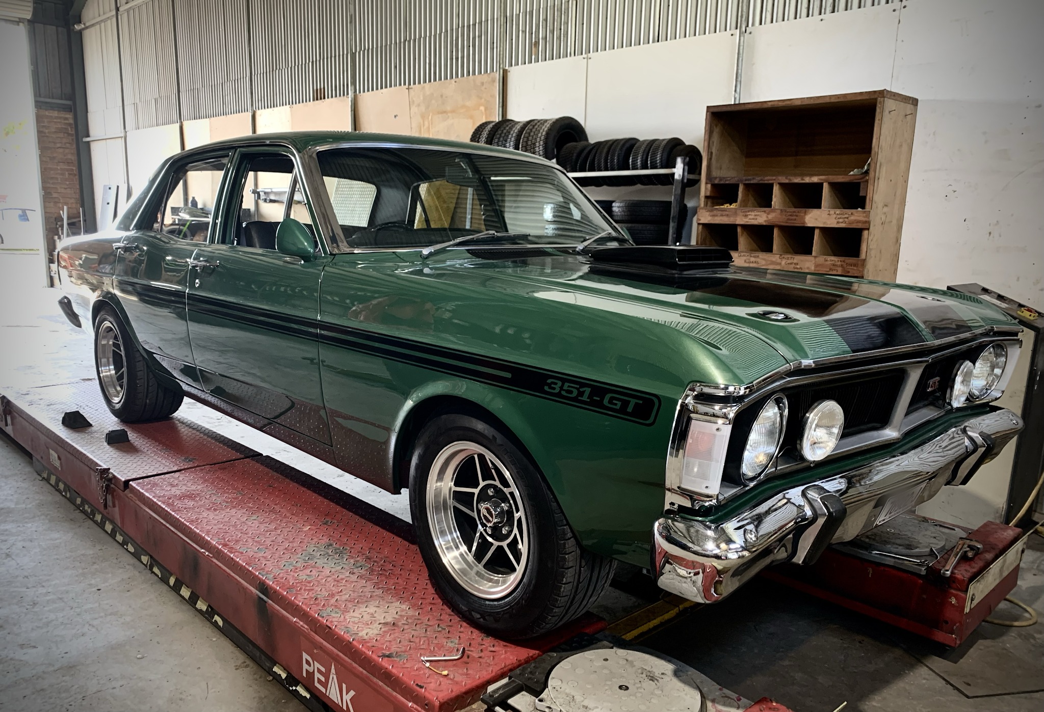 A green Ford Falcon 351 GT sitting on the alignment rack in the Str8line workshop