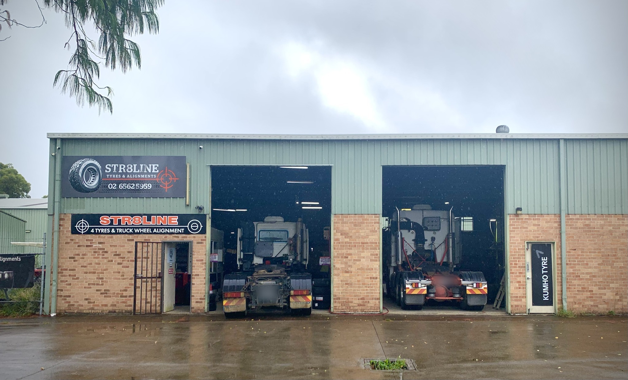Two prime movers pulled into the two workshop bays at Str8line on Queen Street